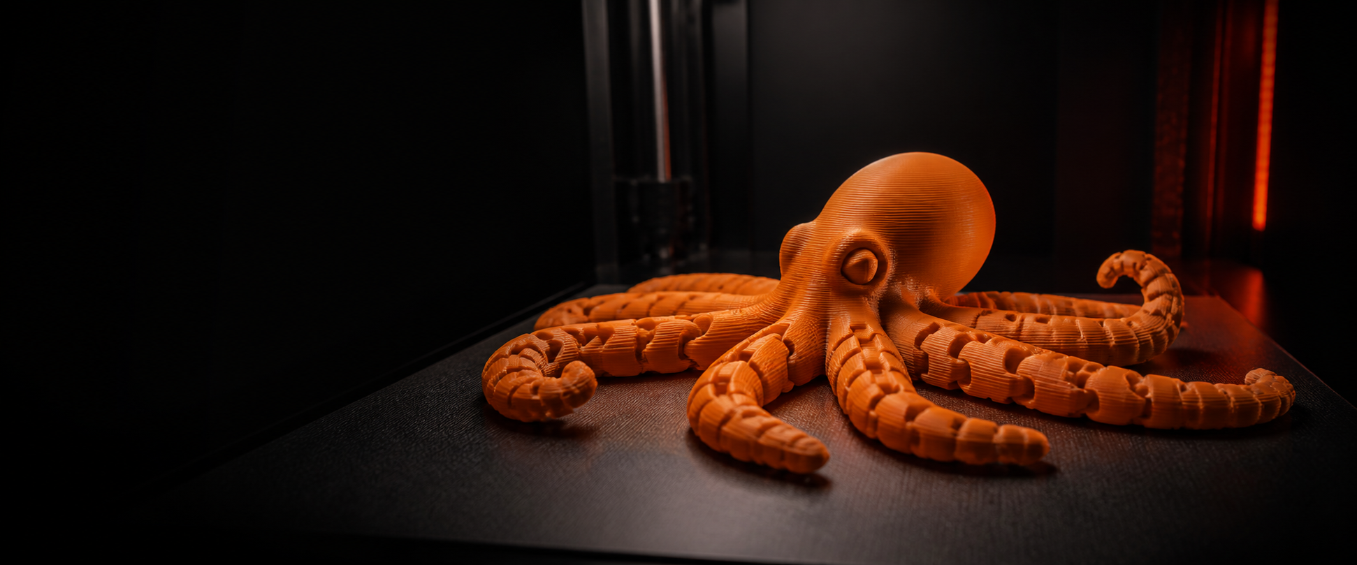 Orange articulated octopus made with visible 3D-printed layers